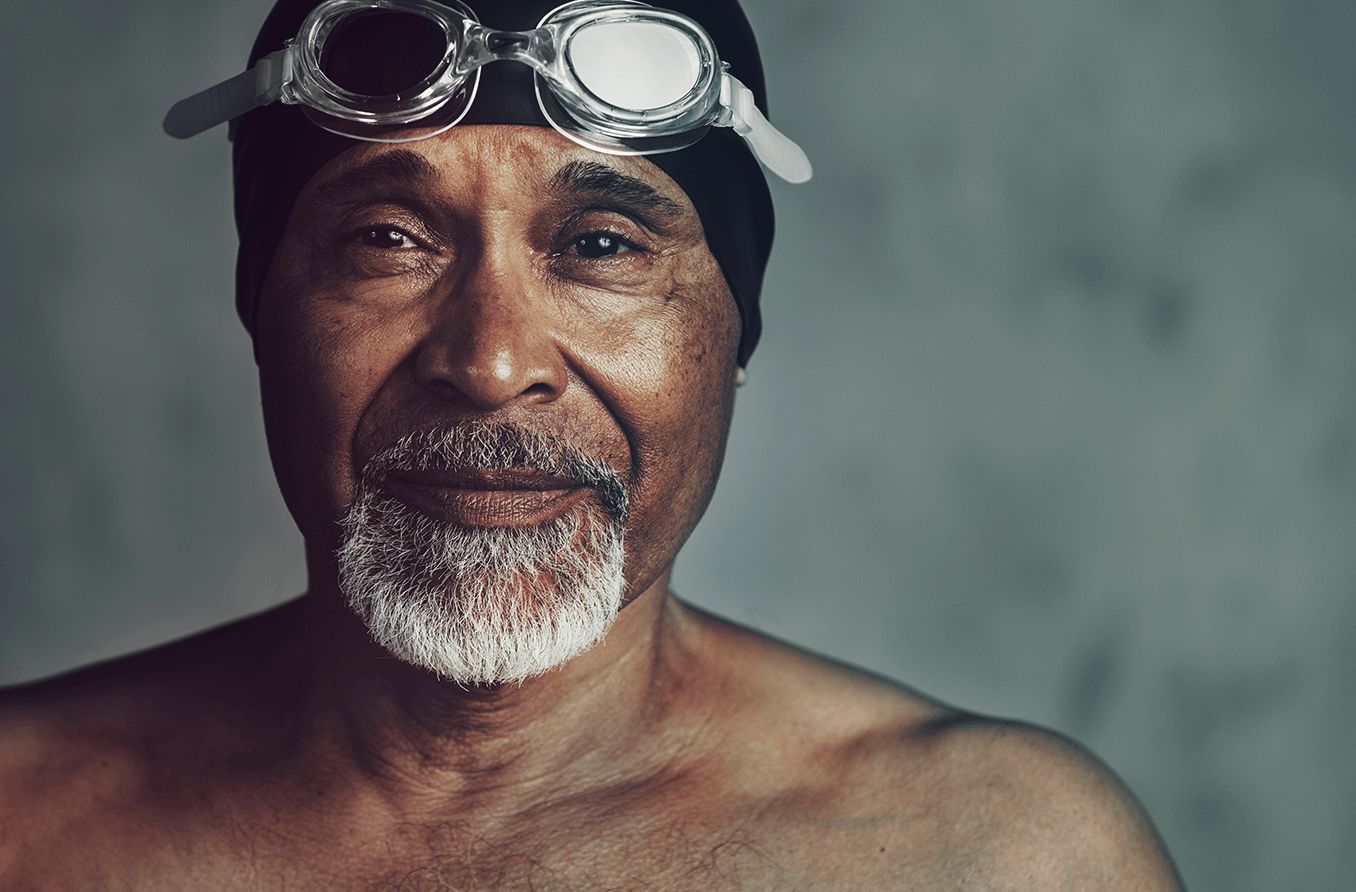 man wearing prescription swim goggles and swim cap