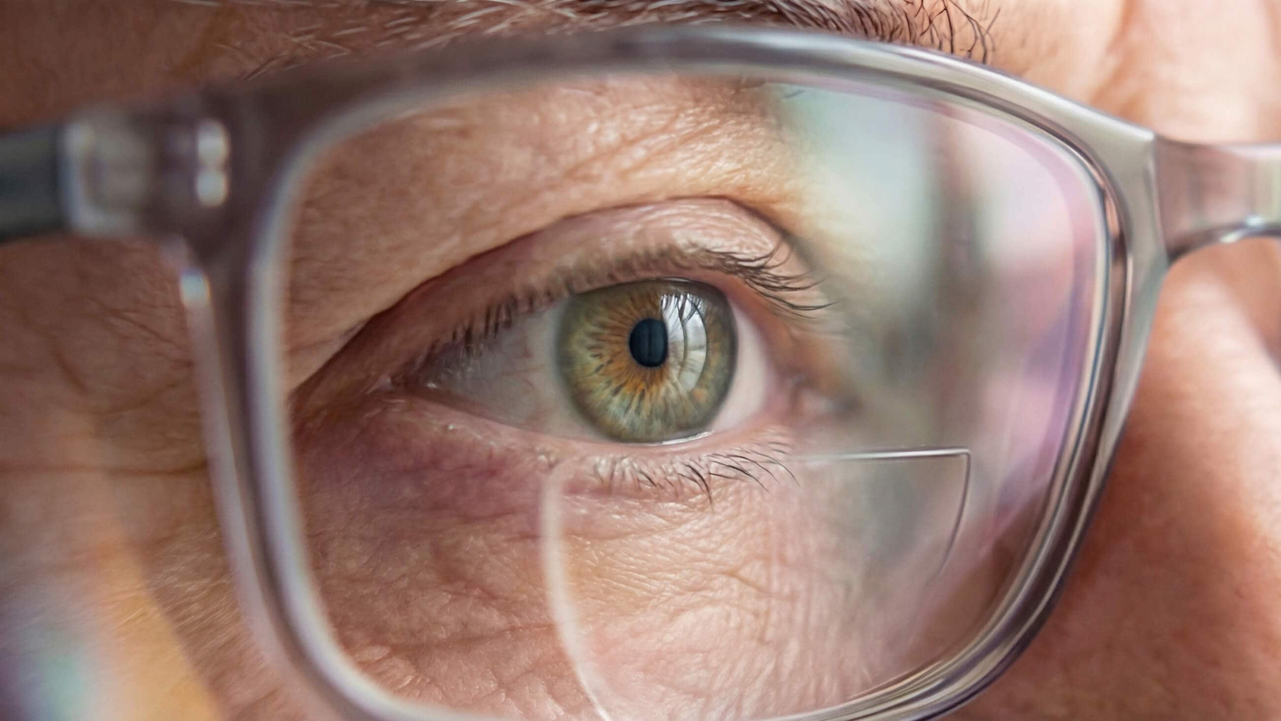 close up image of man's eye wearing bifocal glasses close up image of man's eye wearing bifocal glasses