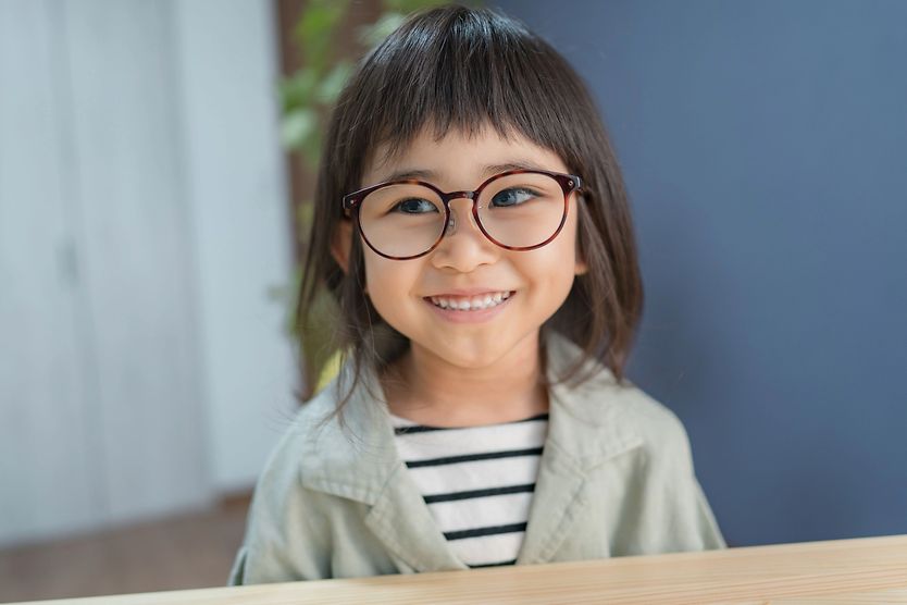 young girl wearing glasses with a lazy eye