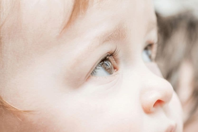 Close-up of child's eyes looking upward. 