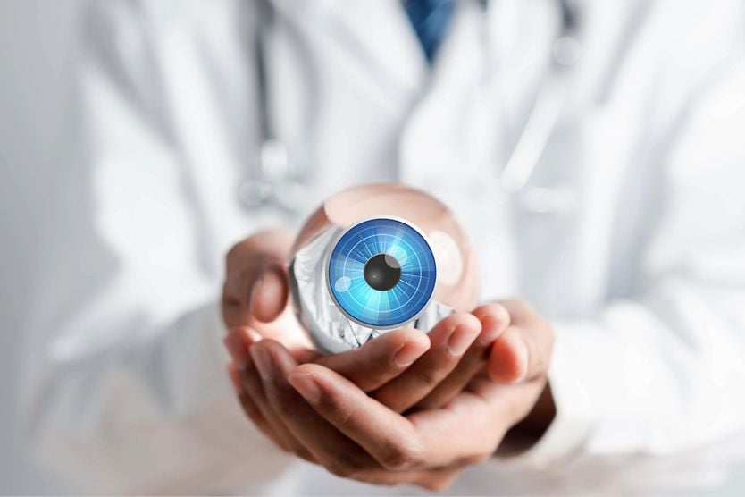 Doctor holding glass object resembling and eye