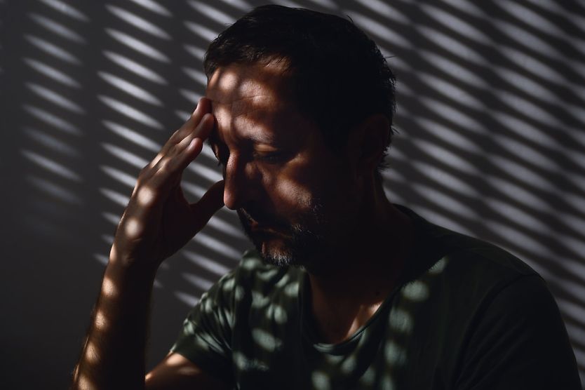 man with eye pain and sensitive to light