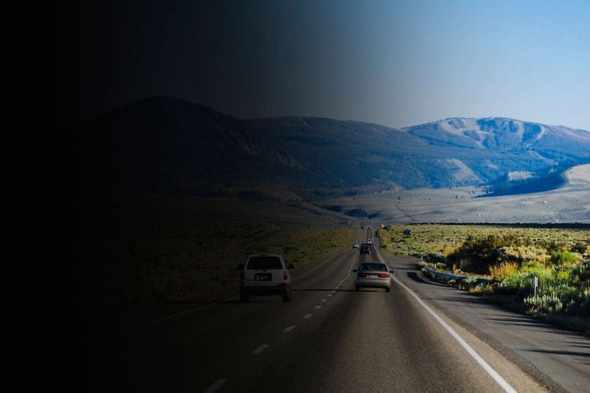 image of road leading to a mountian with the left side blacked out