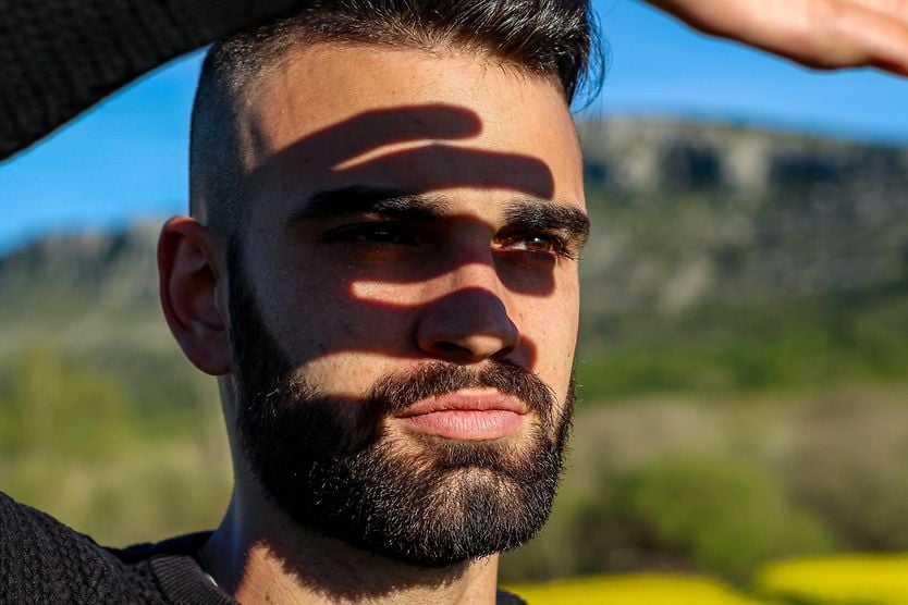 Man shielding his eyes from the sun