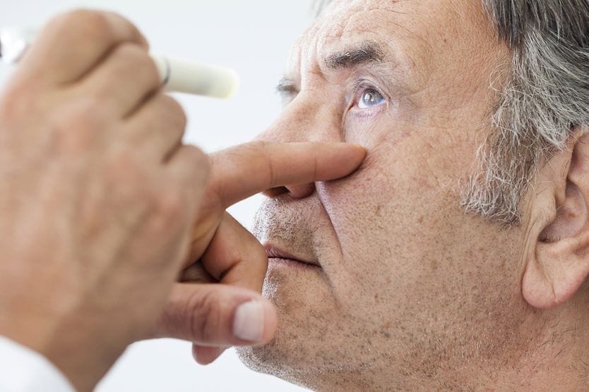 man getting eye exam checking for ocular melanosis