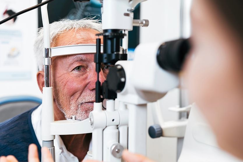What is retinoschisis? elderly man getting eye exam checking for retinoschisis