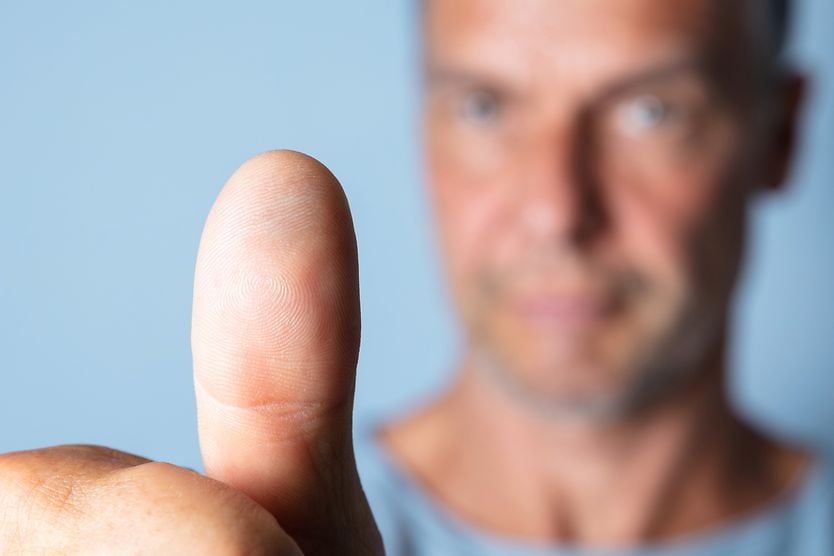 Eye exercises for astigmatism man holding thumb out focusing on astigmatism eye exercises
