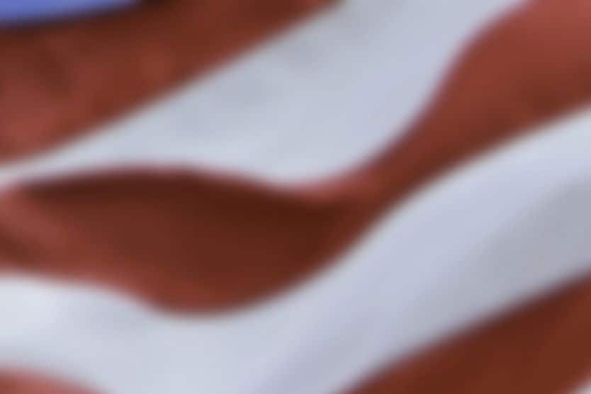 Resources for Visually Impaired Veterans Veteran with low vision saluting with American flag in background