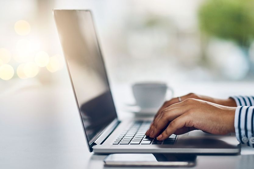 close up of person typing on laptop