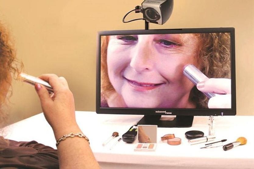 person using magnifying camera low vision aid