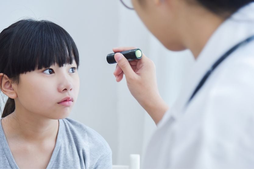 young girl getting eye exam to get checked for pediatric cataracts