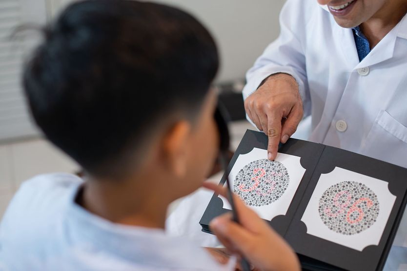 young boy getting a type of color blindness test