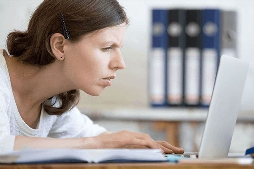 Computer ergonomics and healthy vision woman with eye strain and improper posture at computer