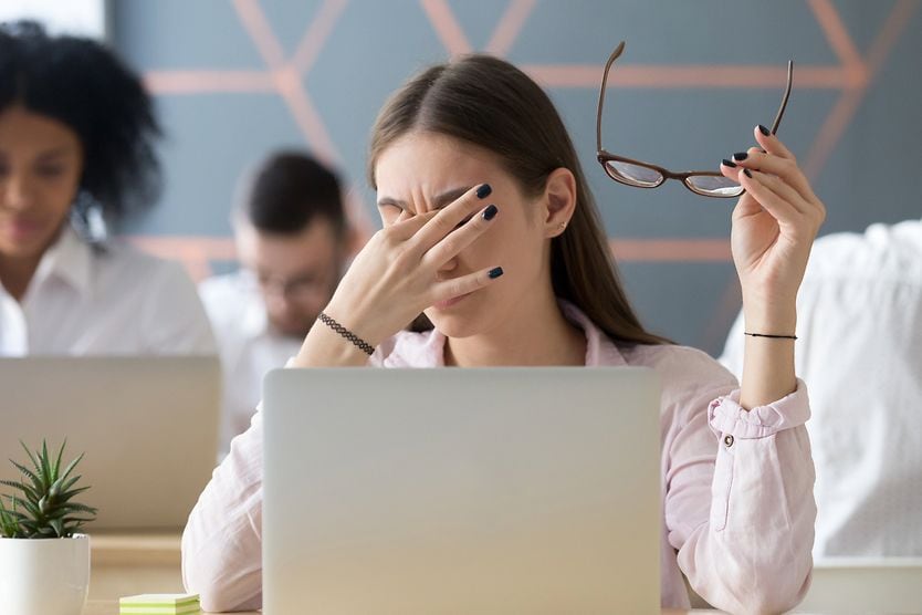 Woman with irritated eyes from prolonged computer use