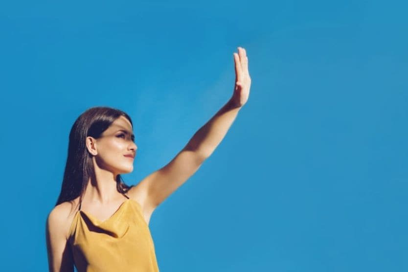Woman shielding sun from her eyes.