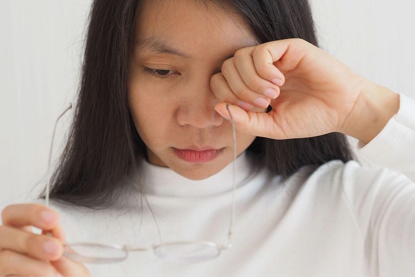 Do eye floaters go away? woman irritated by her eye floaters