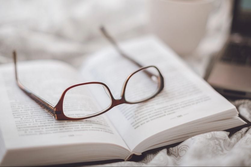 eyeglasses on top of a book