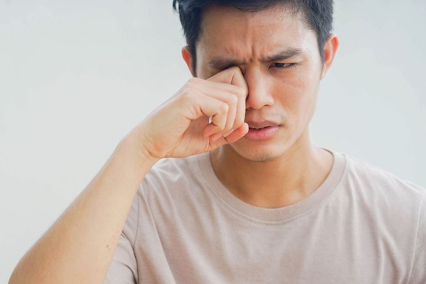 Giant papillary conjunctivitis: Causes, symptoms and treatment man rubbing eye due to giant papillary conjunctivitis