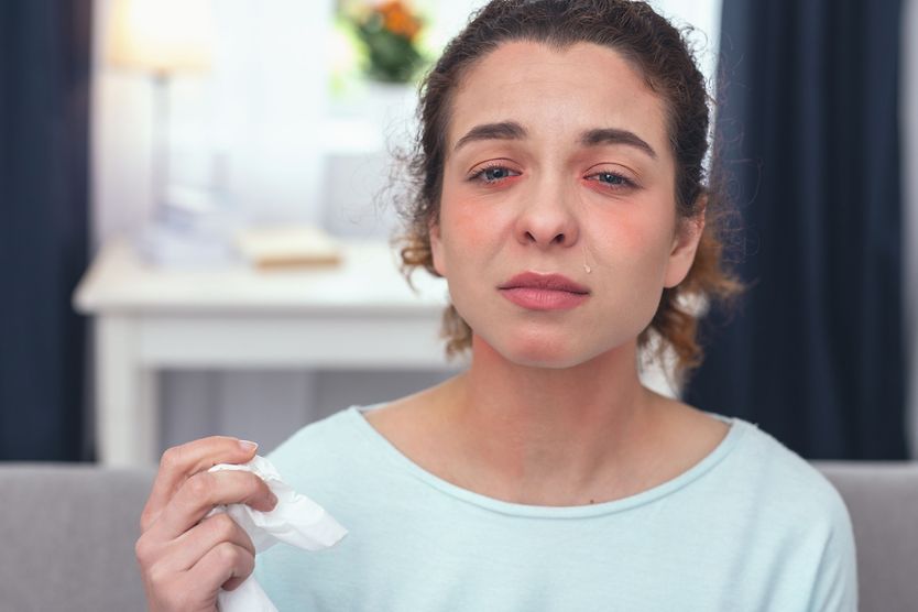 young woman with pink eye symptoms