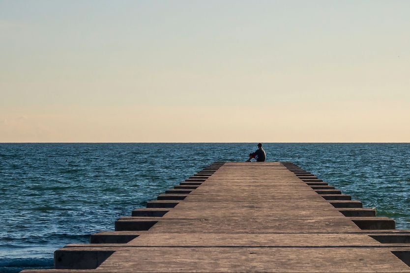 Can staring at the distance cure nearsightedness (myopia)? person at the end of the dock staring out into the distance hoping for a nearsighted cure