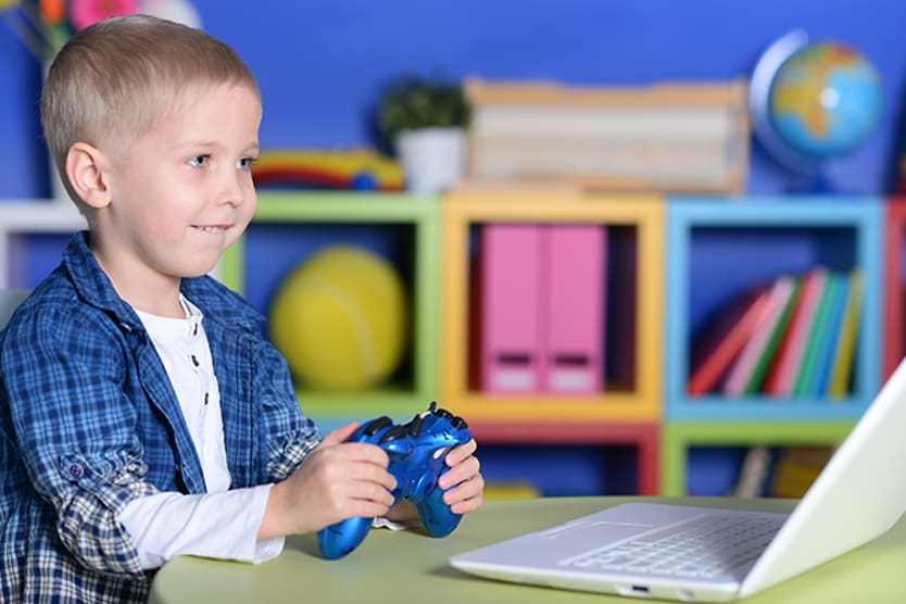 Myopia in children: Is your child at risk? Young boy playing video game
