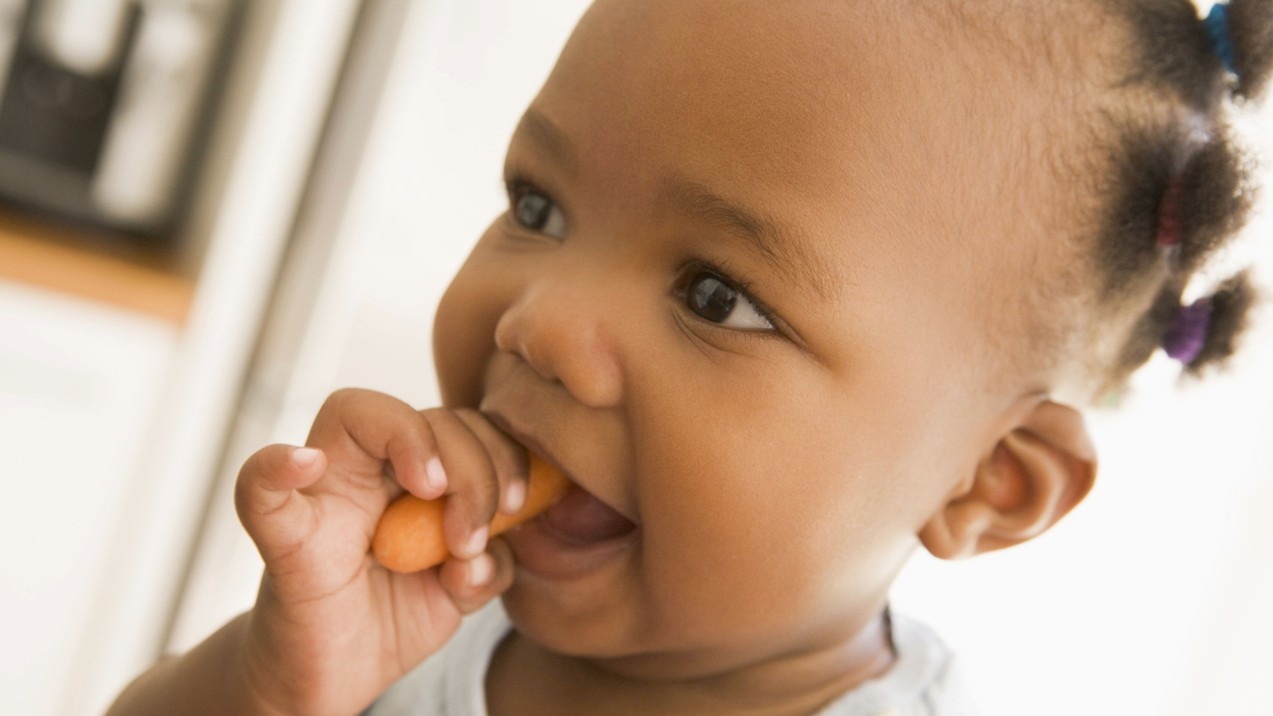child eating a carrot