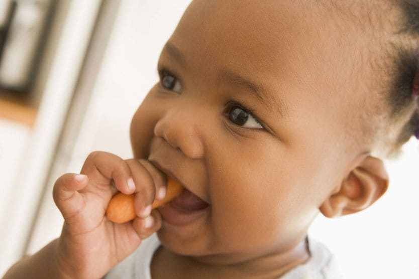 Can eating carrots improve your eyesight? child eating a carrot