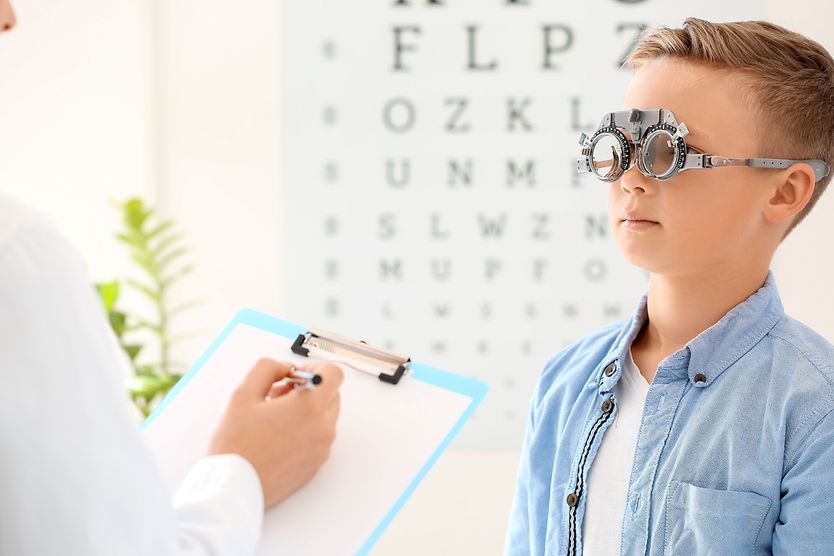 boy getting an eye exam with high myopia