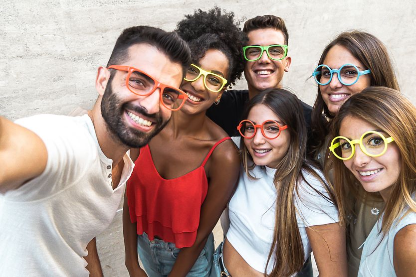 A group of young adults wearing glasses for myopia as an example of how common nearsightedness is.