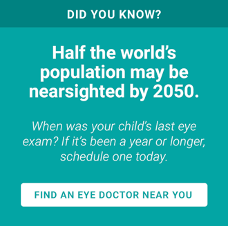 A woman with myopia wearing glasses at her optician's office wearing glasses looking at a new pair of frames.