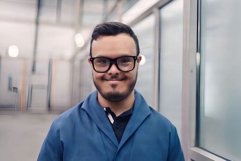 down syndrome man smiling wearing glasses