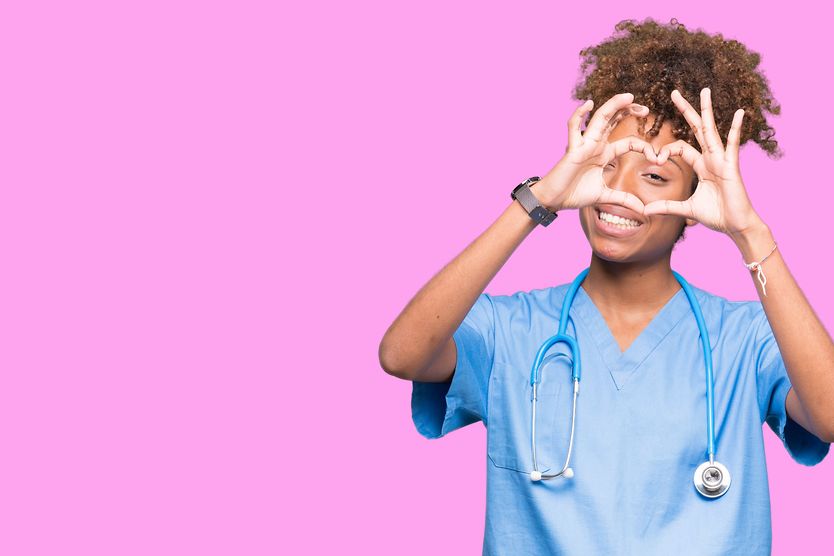 What your eye doctor can tell about your heart health doctor holding up fingers to her eye in the shape of a heart