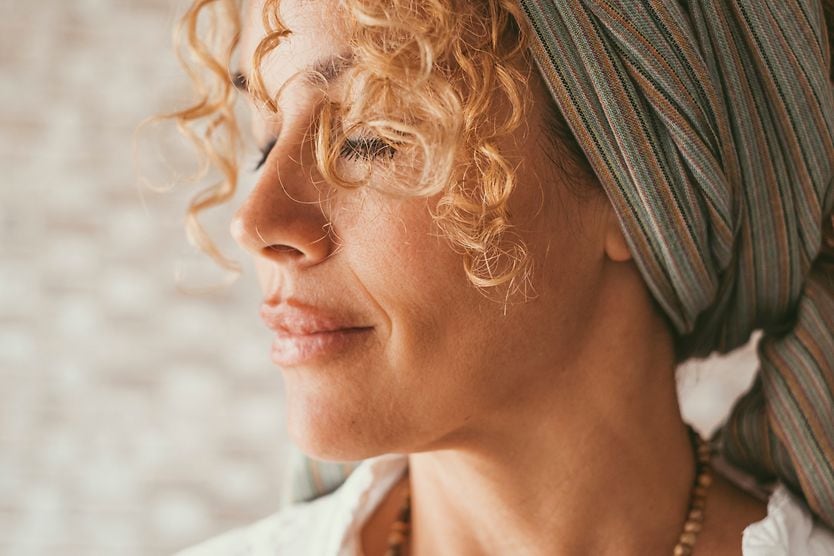 Woman closing her eyes with a peaceful look on her face