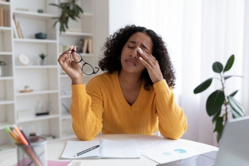 Woman rubbing her eyes.