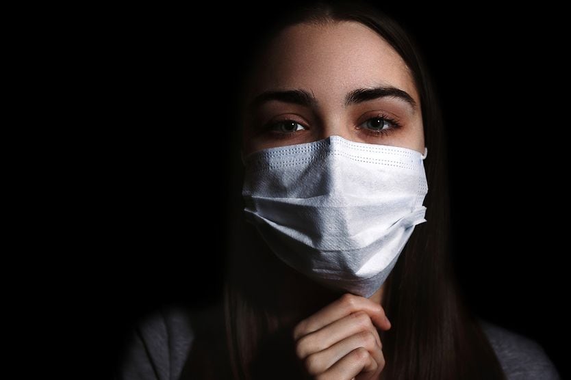 Does COVID-19 Omicron XBB.1.16 (Arcturus) variant raise conjunctivitis risk? Woman wearing mask to prevent spread of virus