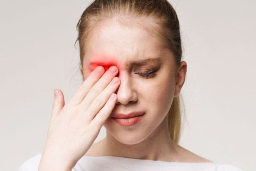 Common Eye Disorders Woman with an eye disorder covering her face with her hands