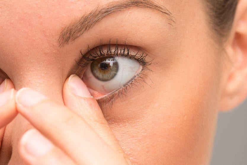 What are eye boogers? woman wiping away her eye boogers