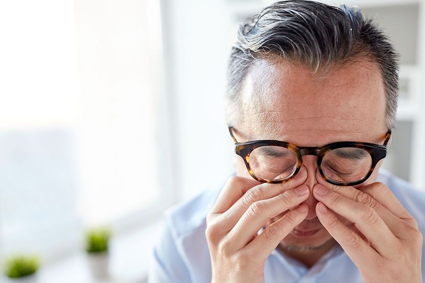 Eye pain: Causes of pain in, around, or behind your eyes and treatment options Man rubbing eyes from eye pain