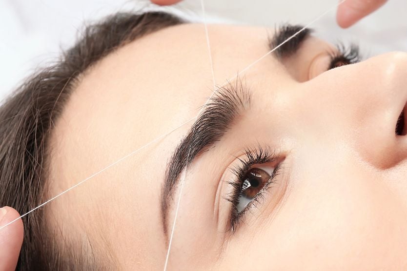 What is eyebrow threading? woman getting eyebrow threading procedure