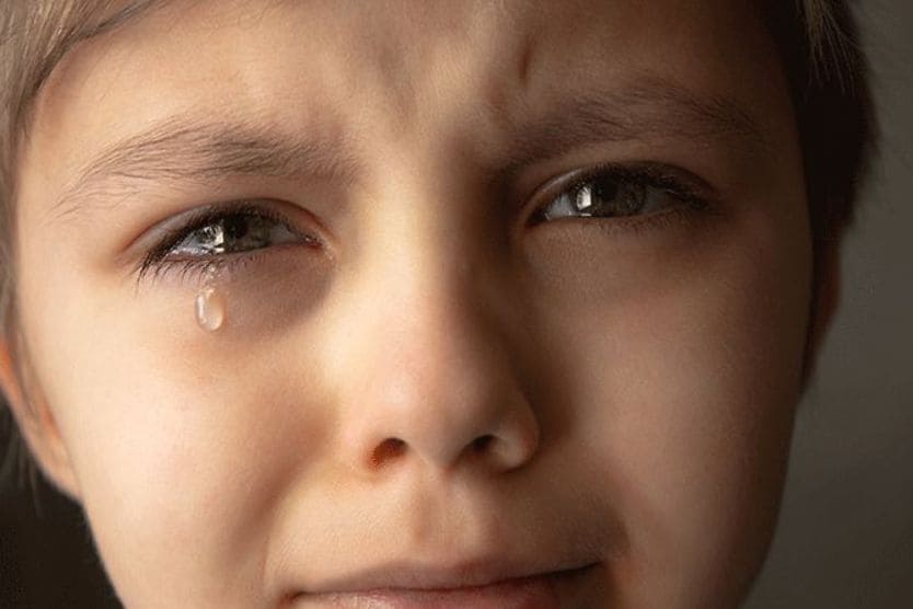 Tears and eye health child with tears coming out of eyes