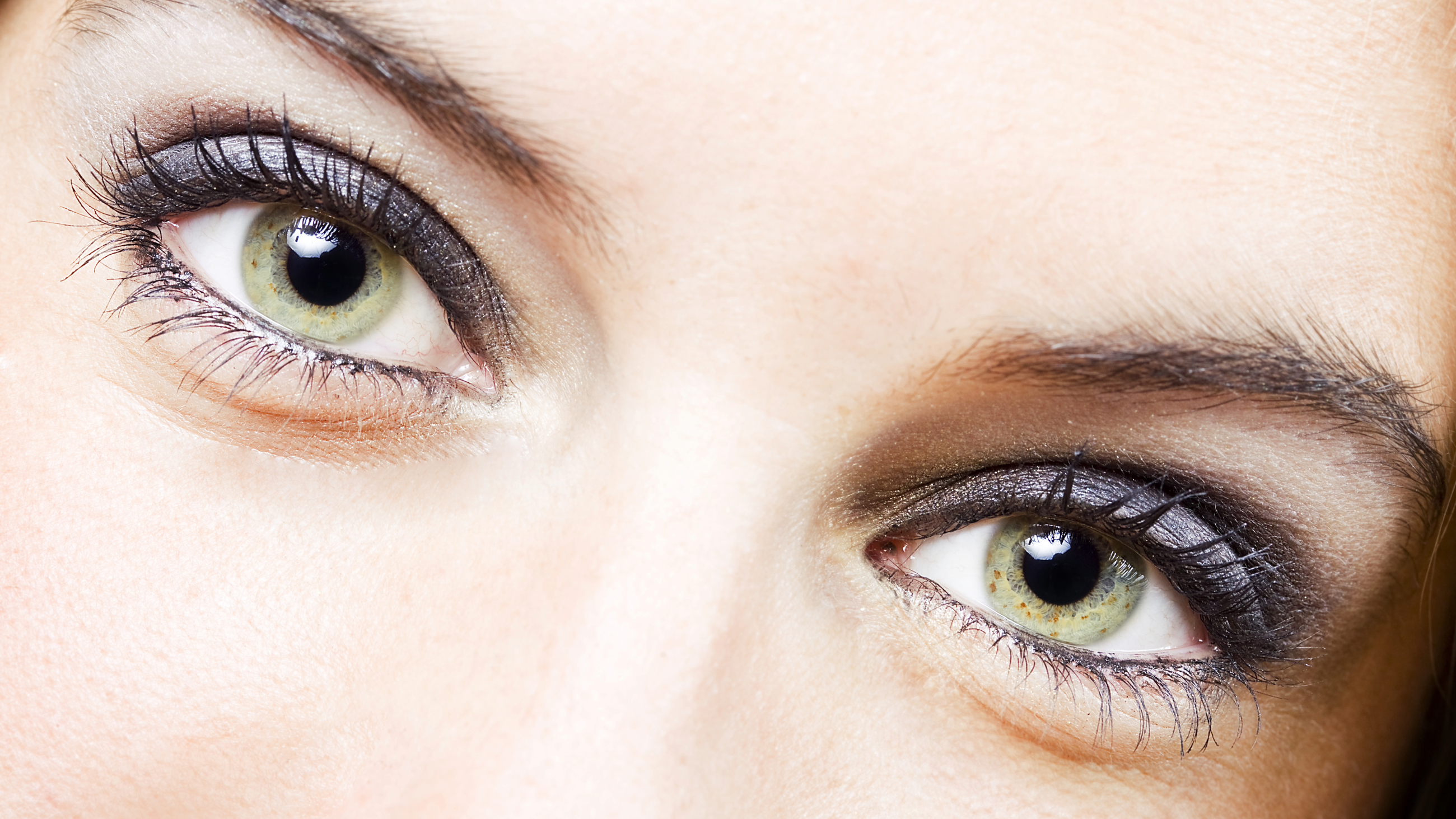 Closeup image of a woman's bright green eyes