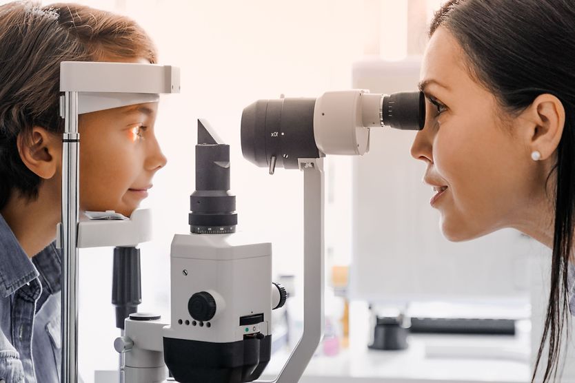 What is a pediatric optometrist? A little boy has his eyes examined by a pediatric optometrist.