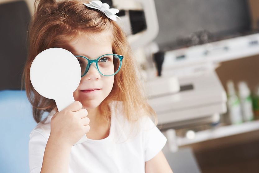 Is it possible to cheat on an eye exam? young girl cheating on her eye exam with the eye cover test