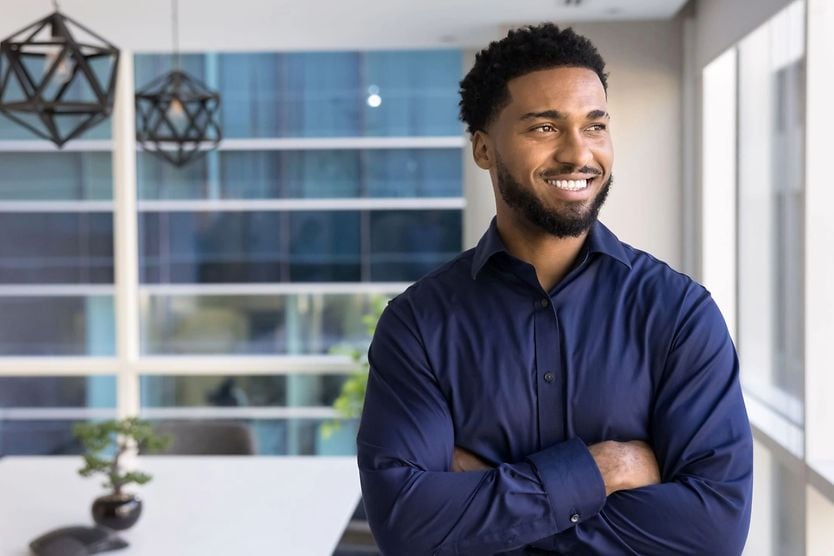 20/20: What is good vision? Business man smiling looking into the distance