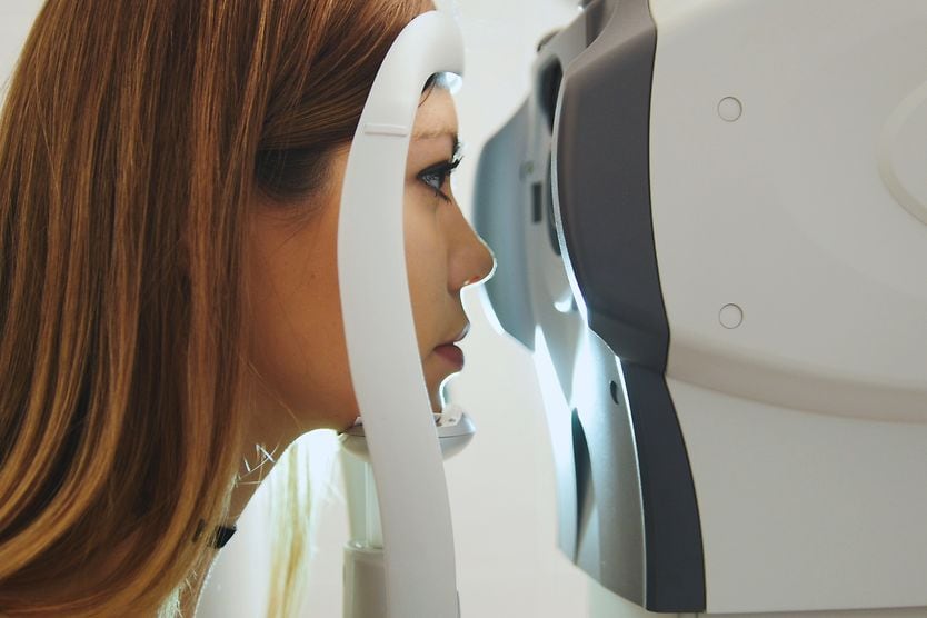 woman getting an eye pressure (intraocular) "air puff" test