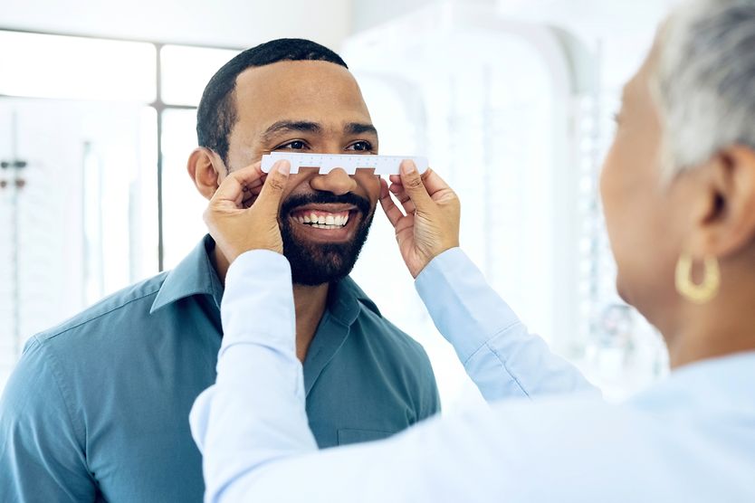 What is pupillary distance, and how do you measure it? eye doctor measuring man's pupillary distance