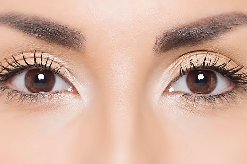 What is the corneal light reflex, and how is it examined? closeup of woman's eye displaying a corneal light reflex during an eye exam