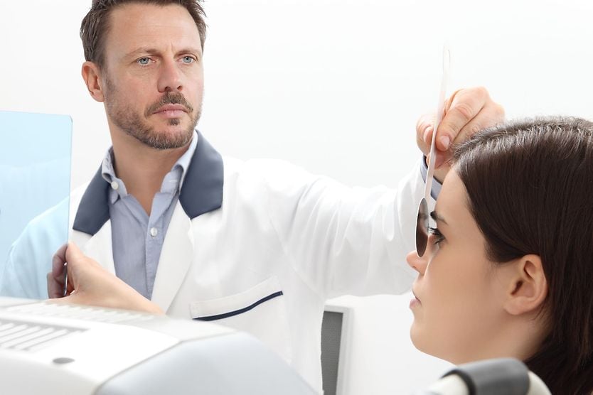 woman at eye doctor getting an eye dominance test