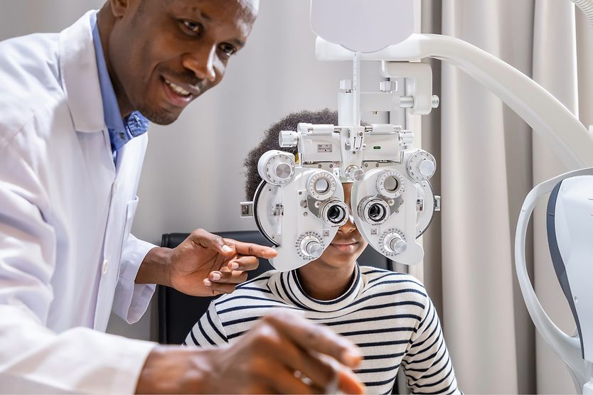 woman getting an eye exam where doctor uses phoropter