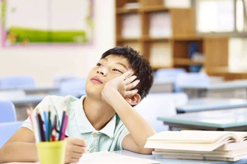 Young boy in school looking in the distance